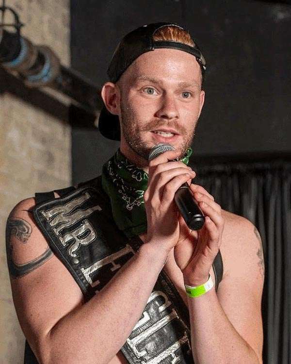 Chris Kelley Chris Kelley Winner of Mr. Eagle NYC 2023 Contest holding a mic